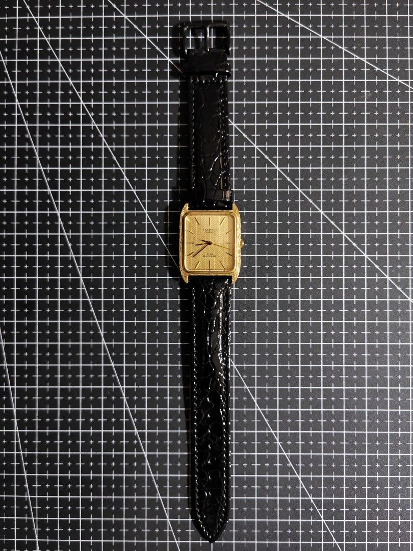 Technos Quartz Gold Square Dial Watch Tank Art Deco (Category: Luxury Watches) located in Makati City. Submitted by reyf86 (Listing ID 1459602323, Image 3). Description: - Technos Gold Square Dial Watch - Quartz Movement - Black Leather Strap with Crocodile Texture - Stainless Steel Back - Model: M27510 - Classic and perfect for everyday wear - In good working condition - Art Deco .
