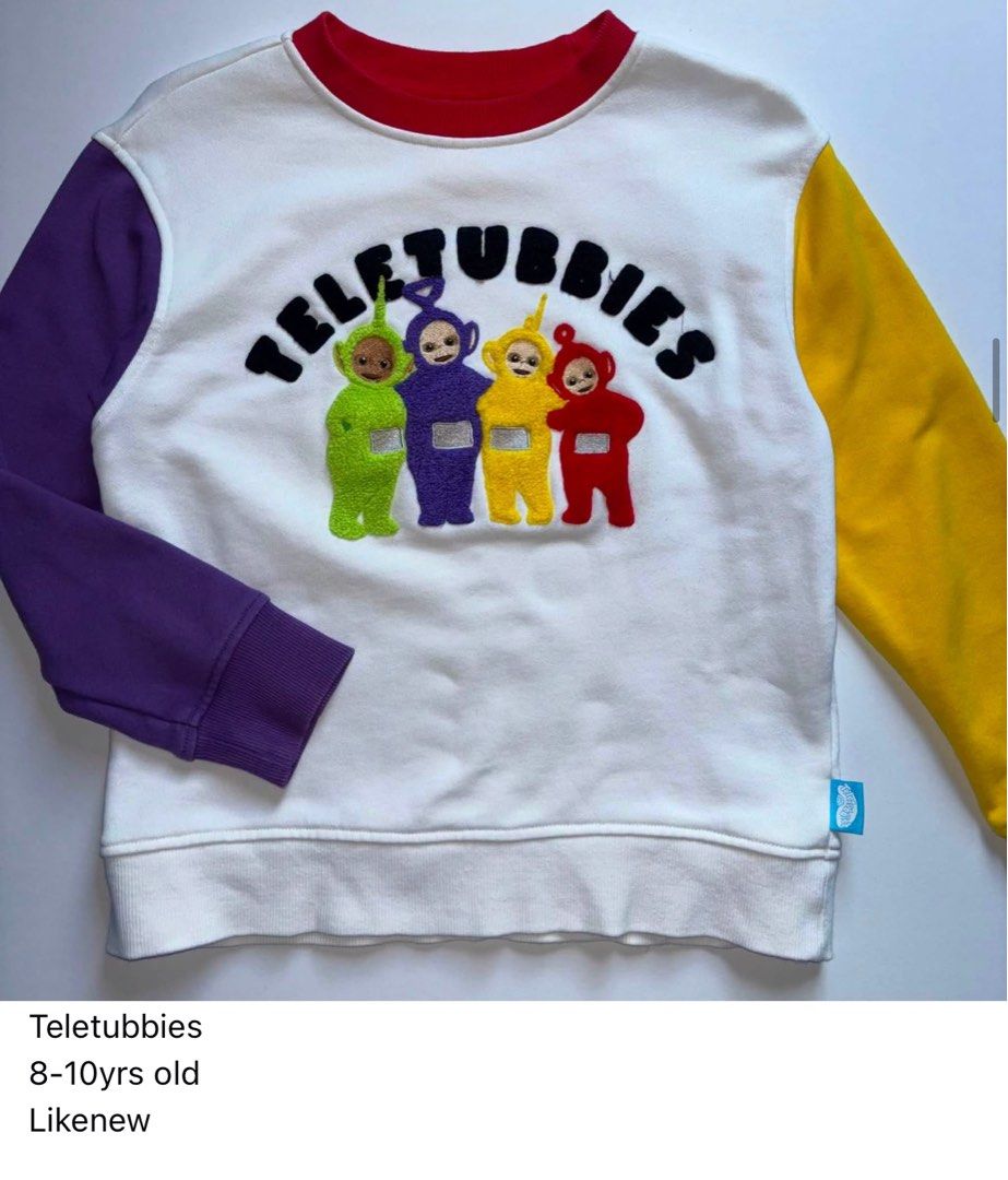 Teletubbies Colour Block Sweatshirt 8-10yrs (Category: Babies & Kids Fashion) located in Manila. Submitted by miamoire (Listing ID 1459618810, Image 1). Description: - Adorable Teletubbies sweatshirt - Features all four Teletubbies characters and logo on the front - Classic white body with contrasting purple and yellow sleeves - Red neckline trim for a pop of color - Ideal for Teletubbies enthusiasts - Great for everyday casual wear.
