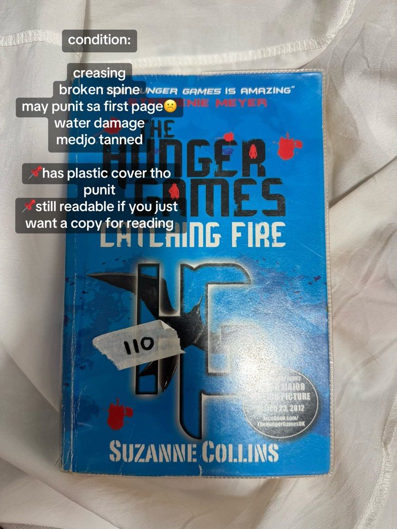 The Hunger Games: Catching Fire by Suzanne Collins (Category: Storybooks) located in Manila. Submitted by cxsnvdra (Listing ID 1459653144, Image 1). Description: - The Hunger Games: Catching Fire paperback - Spine is broken and cover has creasing - Possible writing on the first page - Comes with a protective plastic cover - Still perfectly readable for fans who just want to enjoy the story.