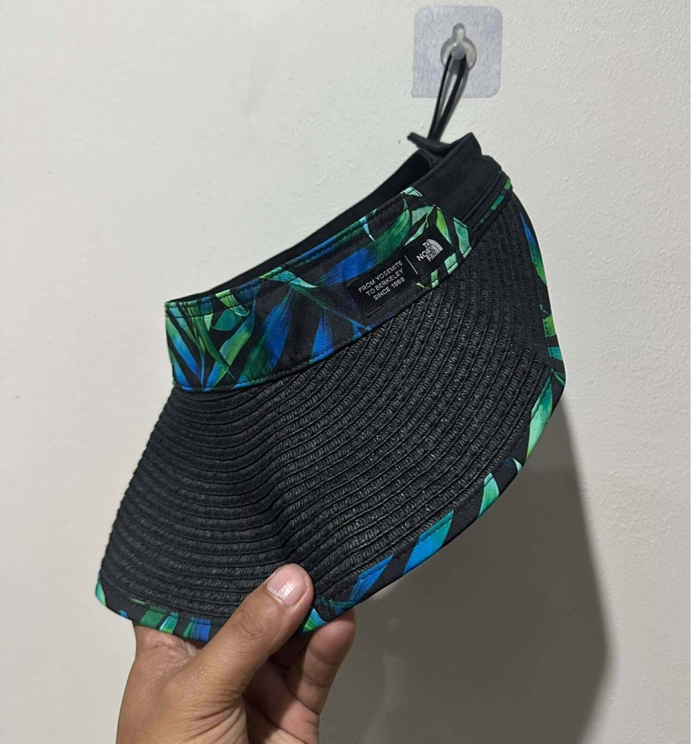 The North Face Visor Hat Tropical Print (Category: Hats & Beanies) located in San Carlos City. Submitted by roseee_012 (Listing ID 1459532292, Image 3). Description: - The North Face visor - Black straw-like material - Tropical leaf print on the band - Adjustable strap at the back - Perfect for sunny days and sun protection - Stylish and functional.