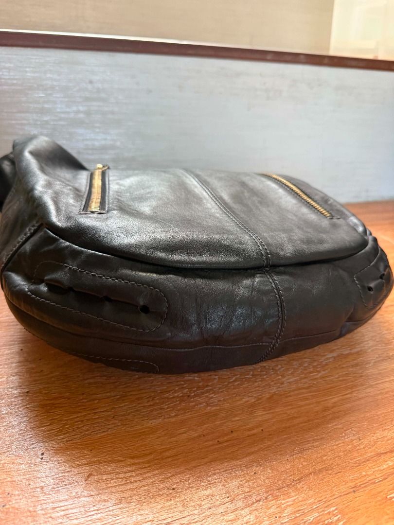 TOD'S Black Leather Hobo Shoulder Bag (Category: Luxury Bags & Wallets) located in Davao. Submitted by shophacks7 (Listing ID 1459562790, Image 3). Description: - Authentic TOD'S black leather hobo bag - Made from soft, supple leather - Features gold-tone hardware with TOD'S branding - Multiple zip pockets on the front - Convenient side pockets - Comfortable shoulder strap - Ideal for everyday use .