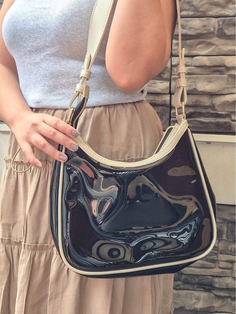 TRANSPARENT HOBO BAG (Category: Shoulder Bags) located in Marikina City. Submitted by dapple (Listing ID 1459621317, Image 1). Description: - Cute shoulder bag - Shiny black exterior with cream trim and strap - Zipper closure - Ideal for carrying essentials - Perfect for casual outings - Multiple colors available (refer to second photo).