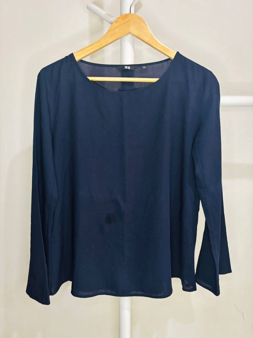 Uniqlo Navy Bell Sleeve Top (Category: Blouses) located in Caloocan City. Submitted by mommycj07 (Listing ID 1459569247, Image 3). Description: Navy blue top from Uniqlo. Long sleeves with a bell flare. Crew neckline. Material has a subtle textured look. Great for dressing up or down. Easy to pair with skirts or pants..