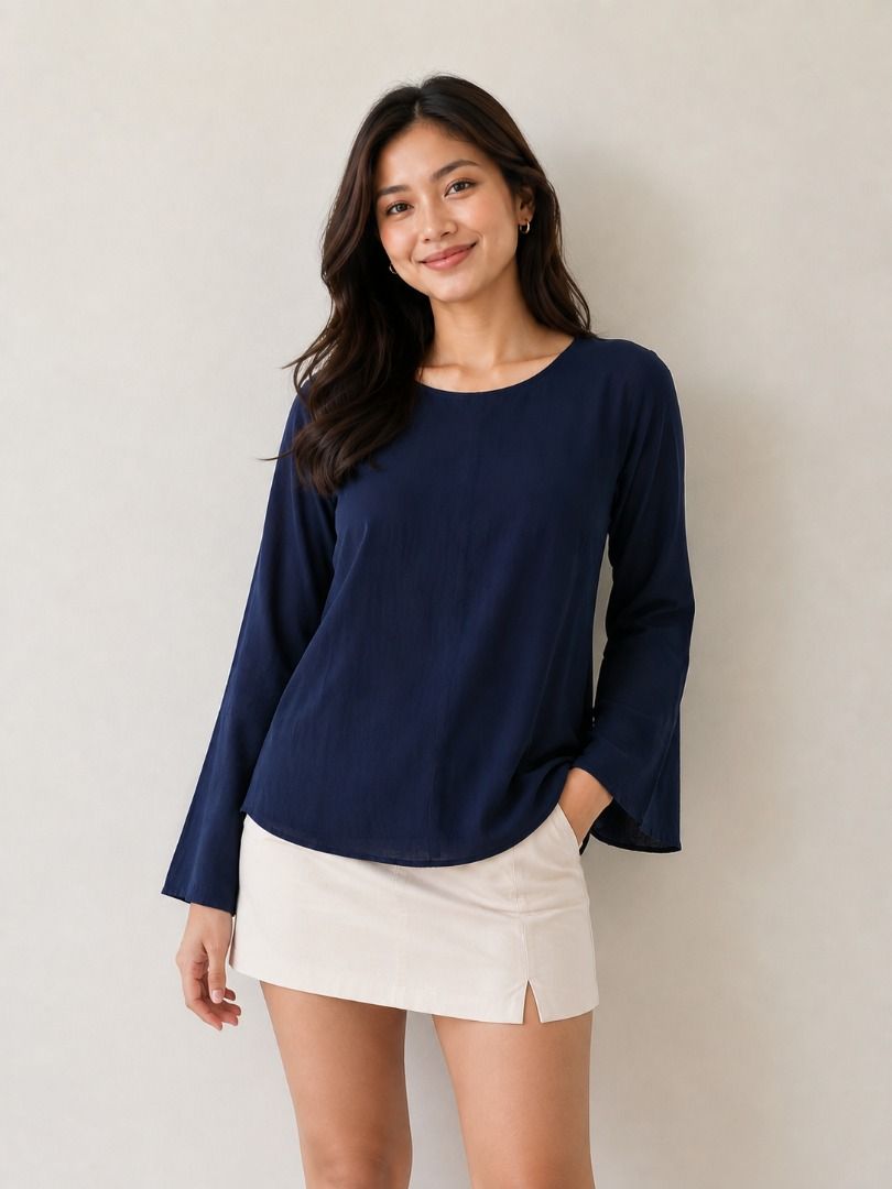 Uniqlo Navy Bell Sleeve Top (Category: Blouses) located in Caloocan City. Submitted by mommycj07 (Listing ID 1459569247, Image 1). Description: Navy blue top from Uniqlo. Long sleeves with a bell flare. Crew neckline. Material has a subtle textured look. Great for dressing up or down. Easy to pair with skirts or pants..