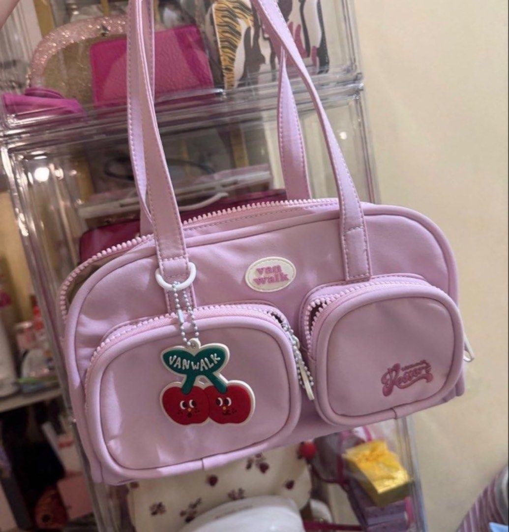 Vanwalk Pink Cherry Charm Shoulder Bag (Category: Shoulder Bags) located in Mandaluyong City. Submitted by nutellay17 (Listing ID 1459614686, Image 1). Description: - Cute pink shoulder bag by Vanwalk - Features a fun cherry charm - Multiple zippered pockets for organization - 'Resort' embroidery detail on the side - Ideal for Y2K or kawaii aesthetics - Perfect for carrying essentials in style.