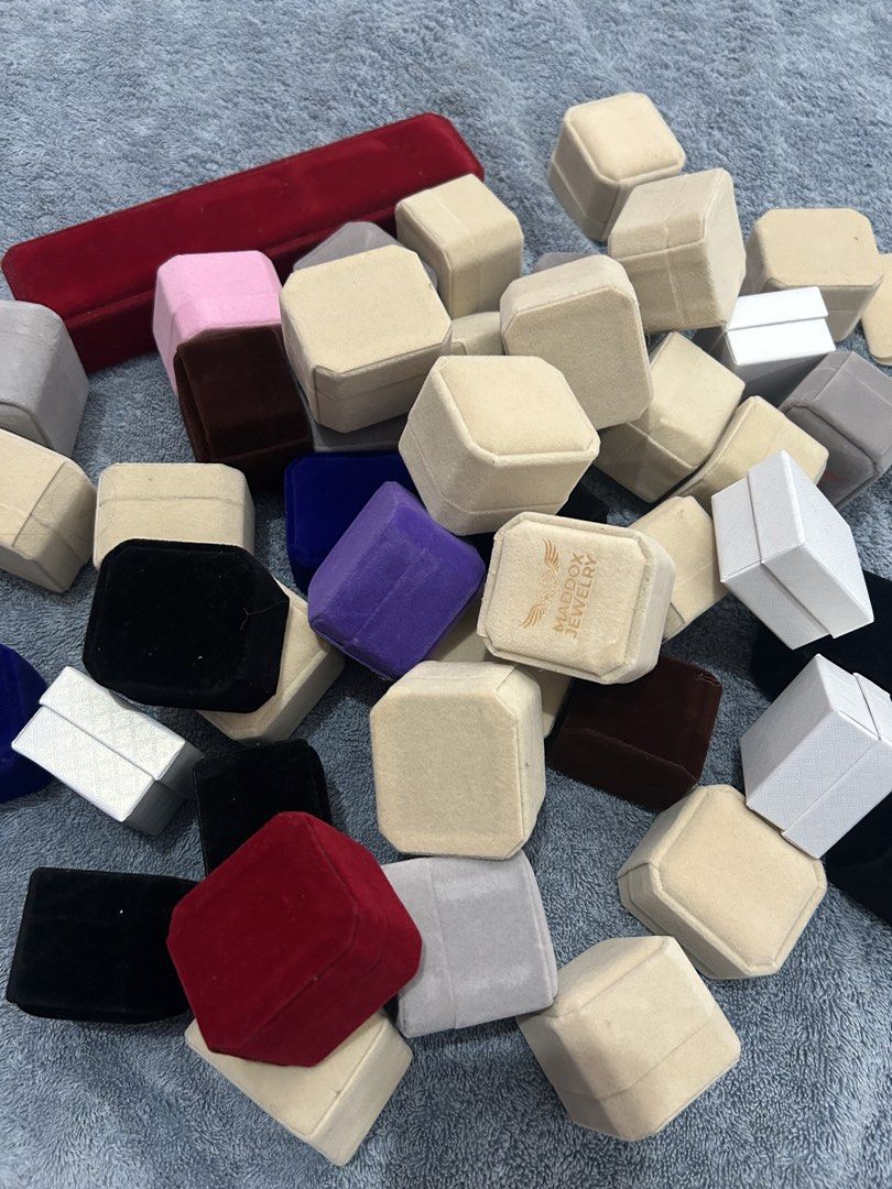 Velvet Ring Boxes Assorted Colors (Category: Accessory Holder, Box & Organizers) located in San Juan City. Submitted by nina1422 (Listing ID 1459496323, Image 3). Description: - Assorted velvet luxury ring boxes available. - Colors include: Beige, Red, Blue, Black, Grey, and Purple. - Some boxes feature the Maddox Jewelry logo. - Perfect for storing rings or small gifts. - Php 25/pc - Total price for all = Php 1,000 - Can purchase per piece, just