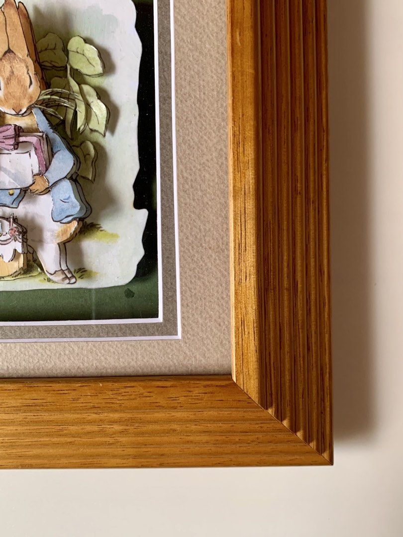 vintage Peter Rabbit 3D decoupage art piece - wallframe (Category: Wall Decor) located in Tandag. Submitted by jeason_22 (Listing ID 1459593049, Image 3). Description: Design Features Style: 3D decoupage or shadow box art, where paper layers are cut and stacked to create depth. Scene: Peter Rabbit wears his classic blue jacket, holds a wrapped gift with a pink bow, and stands near a small birthday cake with candles. Frame: Set inside a textured, 