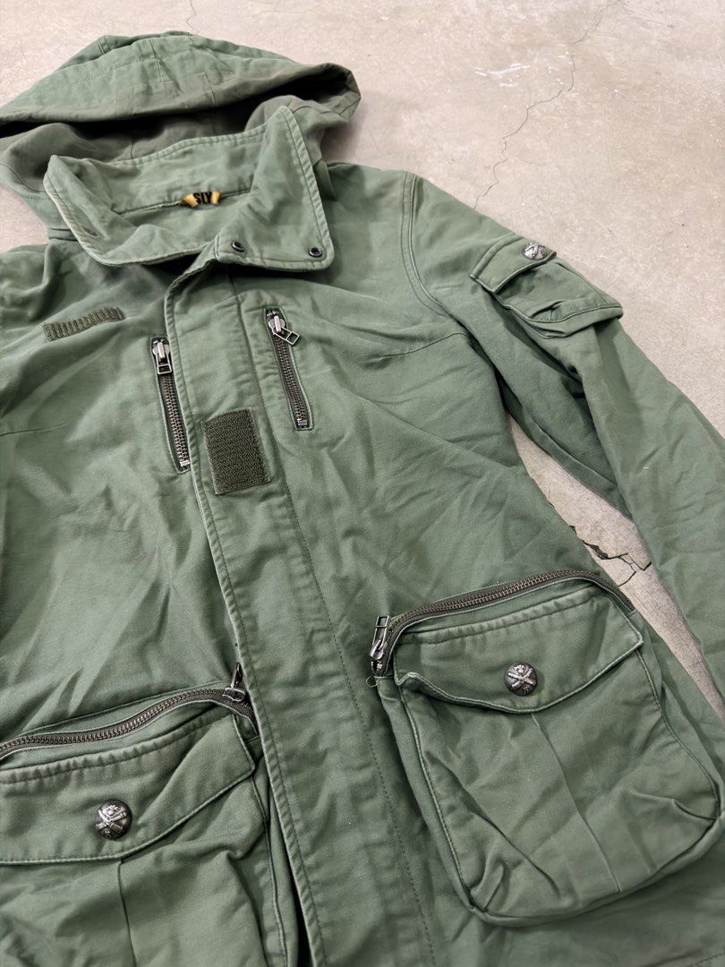 Vintage SLY Green Hooded Utility Jacket (Category: Coats, Jackets and Outerwear) located in Alfonso. Submitted by jbcamet (Listing ID 1459627101, Image 3). Description: - SLY green utility jacket - Features a hood - Multiple pockets for storage - Zipper closures on front and chest pockets - Button closures on main pockets - Made in China - Ideal for everyday wear.