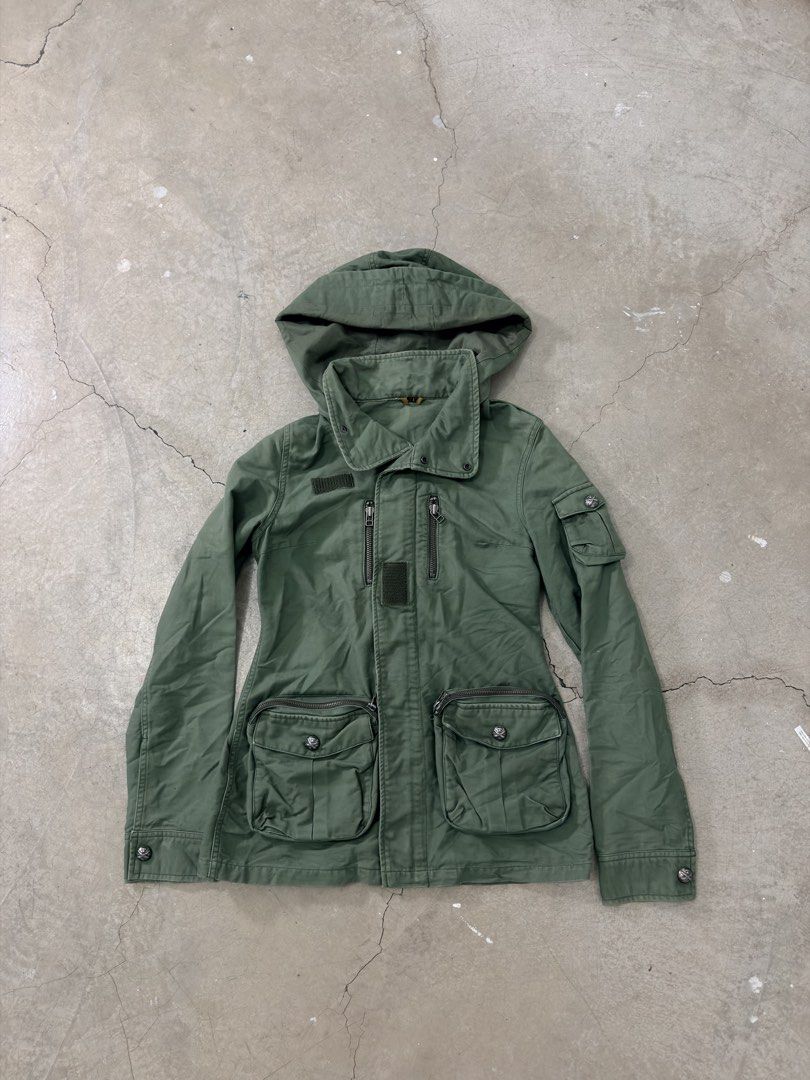 Vintage SLY Green Hooded Utility Jacket (Category: Coats, Jackets and Outerwear) located in Alfonso. Submitted by jbcamet (Listing ID 1459627101, Image 1). Description: - SLY green utility jacket - Features a hood - Multiple pockets for storage - Zipper closures on front and chest pockets - Button closures on main pockets - Made in China - Ideal for everyday wear.