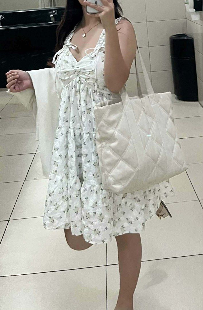 White Floral Tiered Ruffle Strap Mini Dress (Category: Dresses) located in Santa Barbara. Submitted by user82739292 (Listing ID 1459584963, Image 2). Description: - Adorable white mini dress with a charming floral print. - Features delicate ruffled straps for a feminine touch. - Stylish tie-front detail adds a flattering silhouette. - Flowy tiered skirt for a playful and breezy look. - Ideal for picnics, casual outings, or a day at the beach. - V