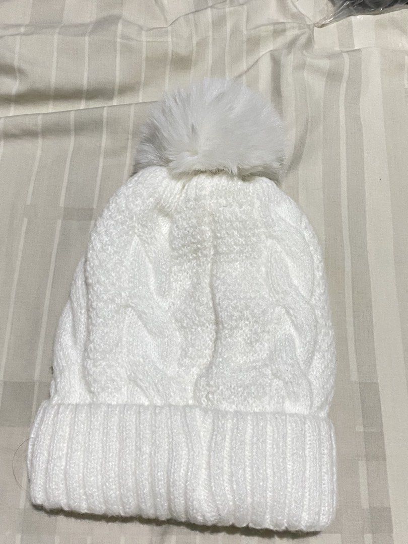 White Knit Beanie with Pom Pom (Category: Hats & Beanies) located in Mandaluyong City. Submitted by awiyoi (Listing ID 1459688166, Image 1). Description: BRAND NEW! NEVER BEEN USED! - Cozy white knit beanie - Features a classic cable knit pattern - Topped with a fluffy white pom pom - Ribbed cuff for a snug and comfortable fit - Ideal for keeping warm during cooler weather rfs: di natuloy sokor trip, need funds, badly need closet space BRAND NEW!