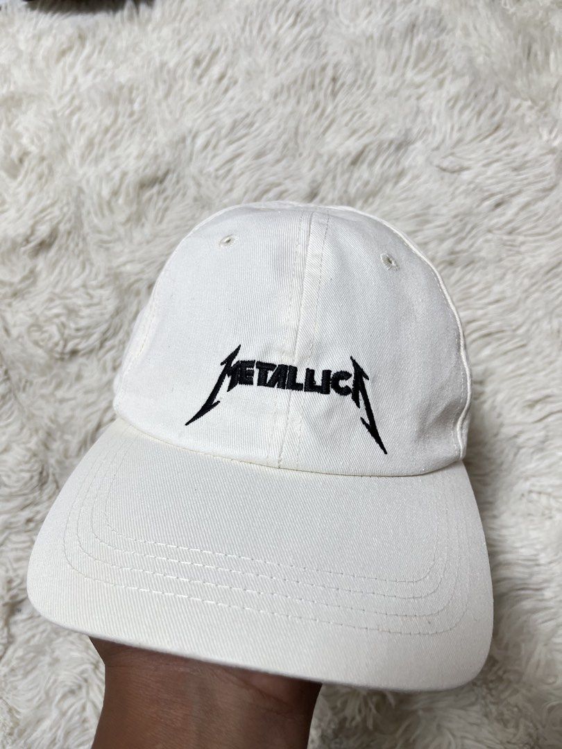 White Metallica Cap - One Size (Category: Caps & Hats) located in General Santos City (Dadiangas). Submitted by crisjayg (Listing ID 1459608389, Image 1). Description: - White baseball cap featuring the iconic Metallica logo embroidered on the front. - Adjustable strap at the back ensures a comfortable and secure fit. - Tag indicates 'one size', suitable for most head sizes. - A must-have accessory for any devoted Metallica fan. - Classic and ver