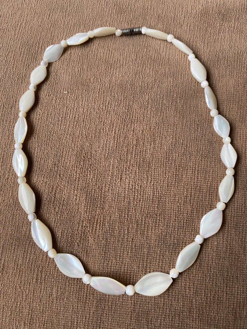 White Swan shell necklace (Category: Necklaces) located in Cebu City. Submitted by janb85 (Listing ID 1459665783, Image 2). Description: A vintage MOP-like swan shell necklace featuring alternating marquise-shaped beads and small round spacers. Sign of wear only on the metal screw-in fastener..