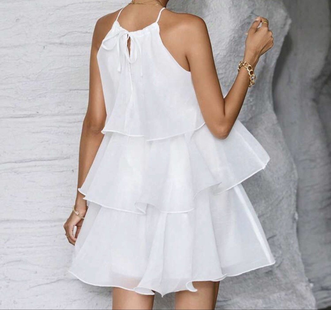 White Tiered Ruffle Halter Neck Mini Dress (Category: Dresses) located in Manila. Submitted by oohwwella (Listing ID 1459578626, Image 2). Description: - Cute white mini dress - Tiered ruffle details - Halter neck with tie closure - Lightweight and flowy fabric - Ideal for summer events and beach trips - Versatile for dressing up or down - Flattering and lovely to wear.