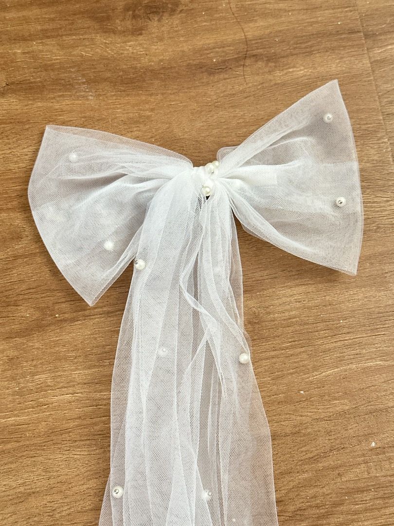 White Tulle Bow Veil with Pearls (Category: Hair Accessories) located in Mandaluyong City. Submitted by lovedbyjaaaam (Listing ID 1459513833, Image 1). Description: - Adorable white tulle bow with a long veil. - Delicately decorated with small pearls all over. - Ideal for parties, weddings, or any special occasion. - Features an easy-to-use attachment. - Approximately X inches long..