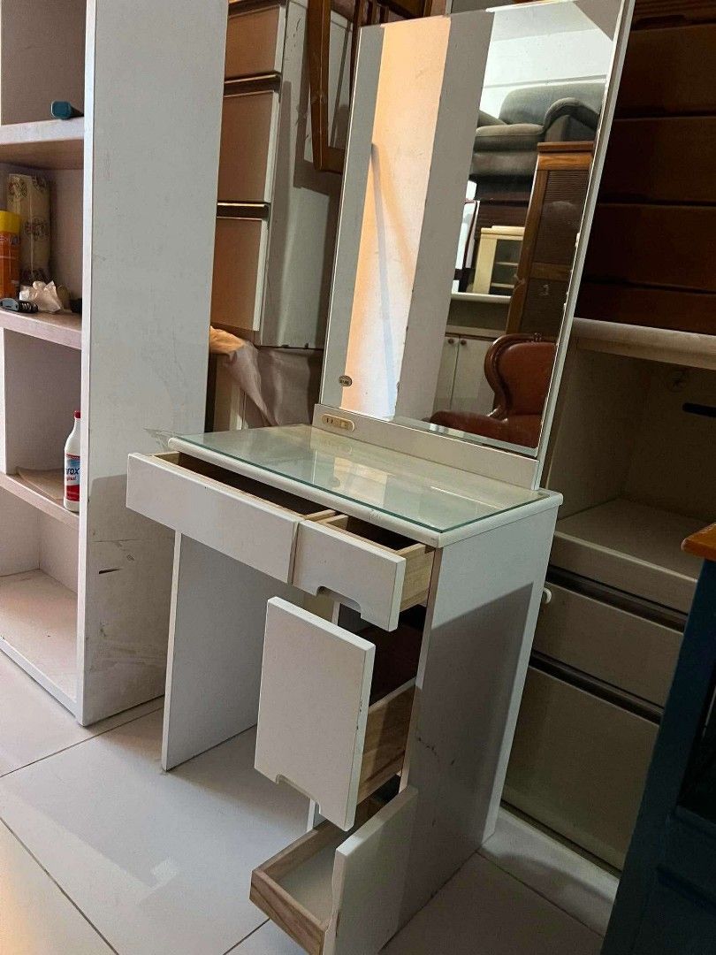 White Vanity Table with Mirror and Drawers (Category: Tables & Sets) located in Antipolo. Submitted by roselle001 (Listing ID 1459574648, Image 2). Description: - Elegant white vanity table - Includes a tilting mirror - Features a sleek glass top surface - Multiple drawers for ample storage (some open in photos) - Ideal for organizing makeup and accessories - Perfect addition to any bedroom or dressing area.