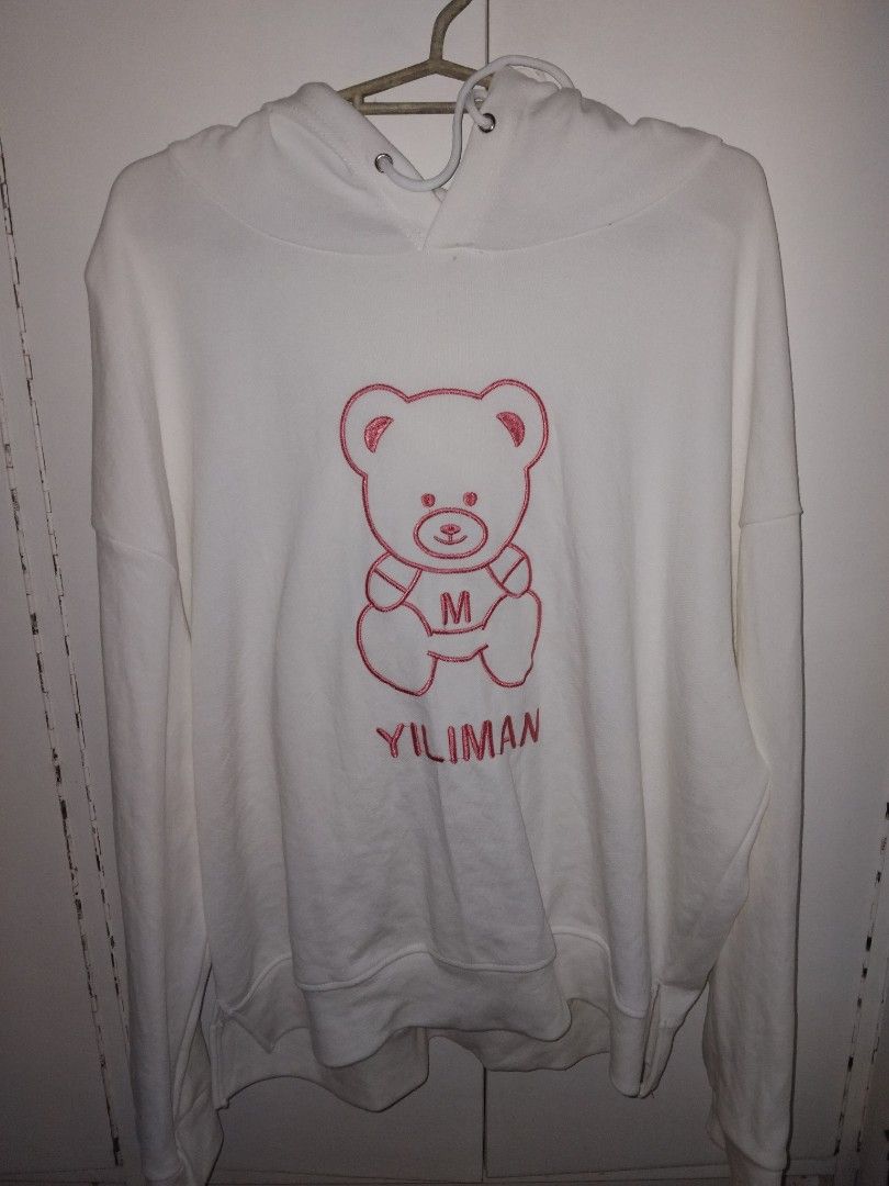 White YILIMAN Hoodie with Bear Graphic (Category: Coats, Jackets and Outerwear) located in Marikina City. Submitted by lyyyyc (Listing ID 1459647628, Image 1). Description: - Cozy white hoodie - Features a cute bear graphic with red outline details - 'YILIMAN' embroidered next to the bear - Long sleeves and hood for extra comfort - Ideal for casual, everyday outfits S/M size, hoodie from hongkong.