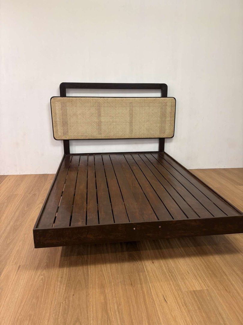 Wooden Bed Frame with Rattan Headboard (Category: Bed Frames & Mattresses) located in Manila. Submitted by shuri_19 (Listing ID 1459538248, Image 2). Description: - Dark wood bed frame - Woven rattan headboard - Modern design, fits most bedroom styles - Sturdy construction - Ready for a new home.