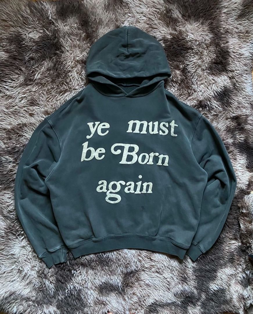 Ye must be born again ( authentic) (Category: Hoodies) located in Meycauayan. Submitted by _trip2thrift.bul (Listing ID 1459674999, Image 1). Description: CPFM born again hoodie boxy in size L. Coal colorway from the OG release (uses the thick Yeezy blank). Some minor cracks, discoloration, and chippage on the puff print. Judge condition by photos. 29x28 boxy type .