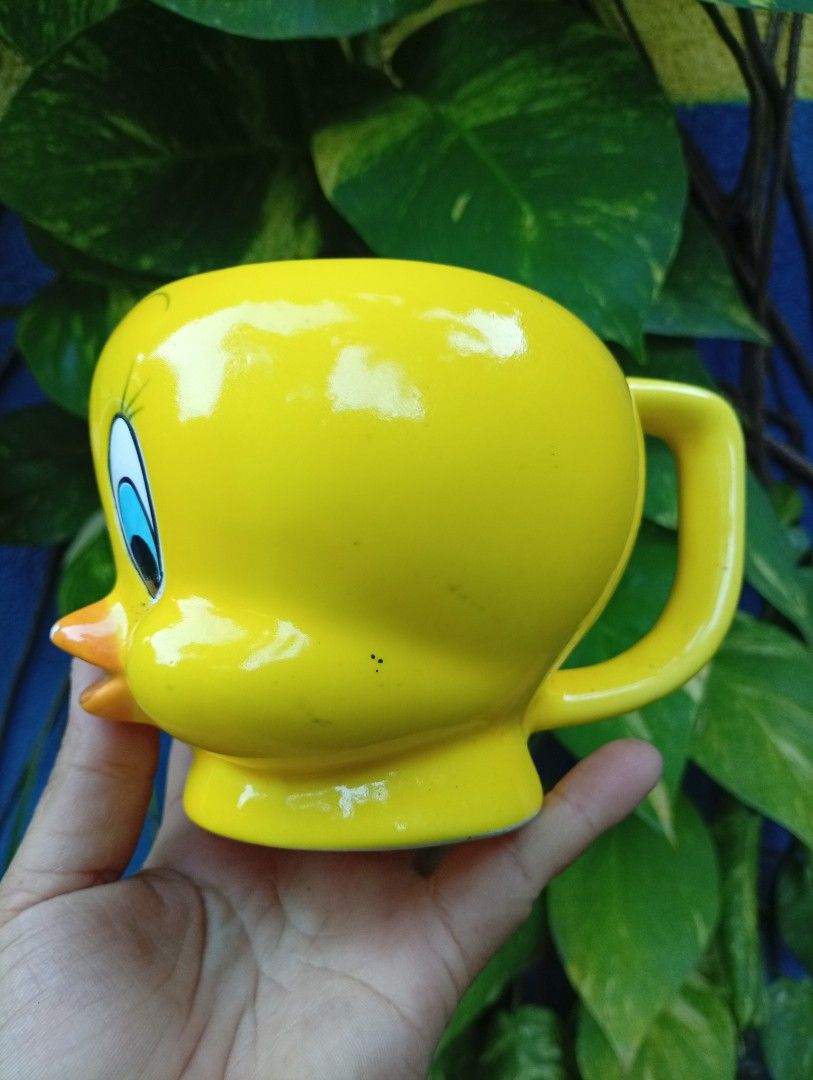 Yellow Tweety Bird Ceramic Mug (Category: Coffee & Tea Tableware) located in Bacolod City. Submitted by closetcleanupbcd (Listing ID 1459650710, Image 2). Description: - Adorable yellow mug shaped like Tweety Bird. - Ideal for enjoying your favorite coffee or tea. - Features a fun design, perfect for any Looney Tunes enthusiast. - Equipped with a sturdy and comfortable handle. - Clean rim on the bottom for stability. - Makes a wonderful gift or a