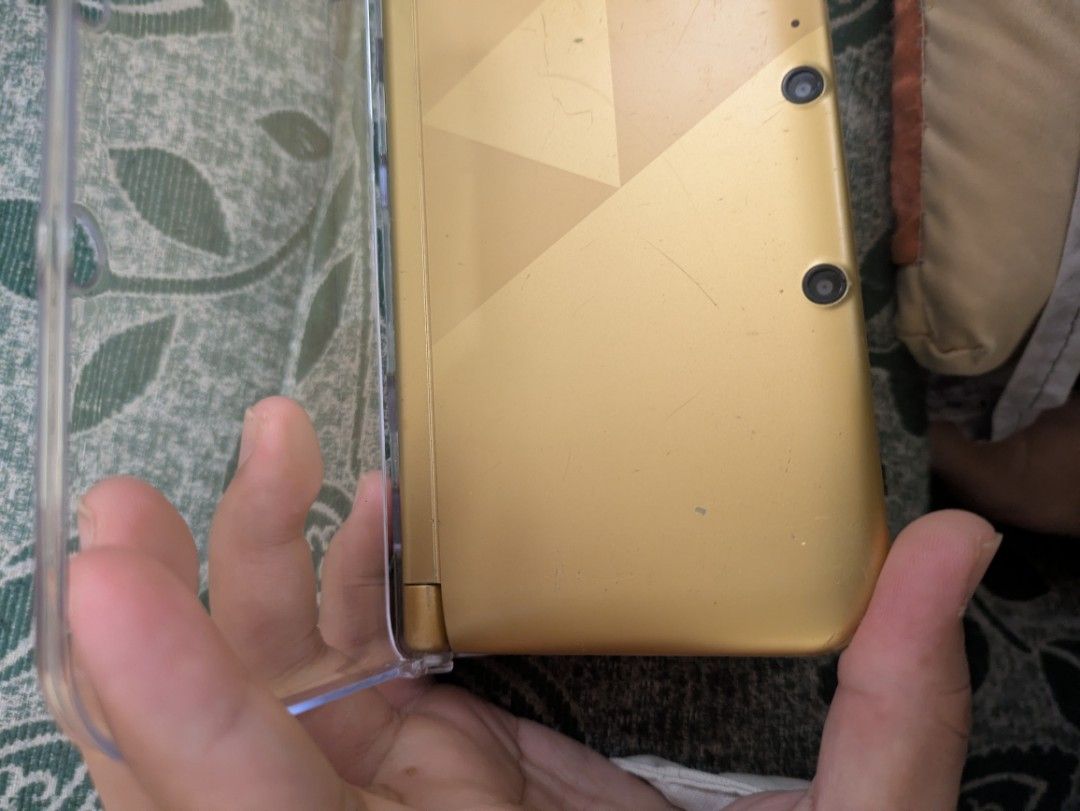 Modded 3DS XL A Link to the Past Edition (Category: Nintendo) located in Batangas. Submitted by Mr.Elyur (Listing ID 1459706132, Image 3). Description: Pm for more pics and condition Rfs: Upgrade. Condition: Front cam needs to be reseated or repaired or replaced, Qr code from fron cam works though. Very slight hinge loose, but fixed with the case. Scratches, sign of usages, a bit of spec in screen. Inclusion: Case Charger Original 64gb Sb card mo