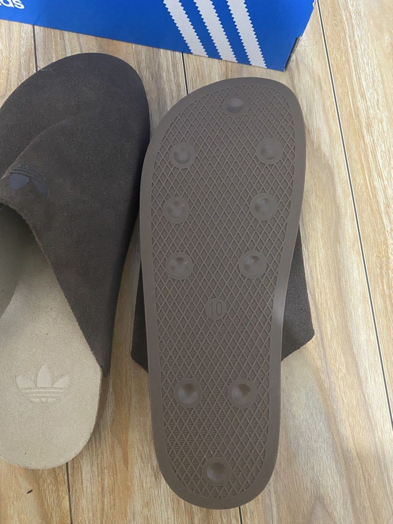 Adidas Brown Clogs (Category: Slippers & Slides) located in Paranaque City. Submitted by mr2kive (Listing ID 1459719916, Image 3). Description: ‼️NON-NEGOTIABLE‼️ - Brand: Adidas - Type: Brown Suede Slides - Size: US 10 / UK 9.5 - Condition: Comes with original box - Ideal for: Casual wear RFS: marami na pong clogs father ko and decluttering .