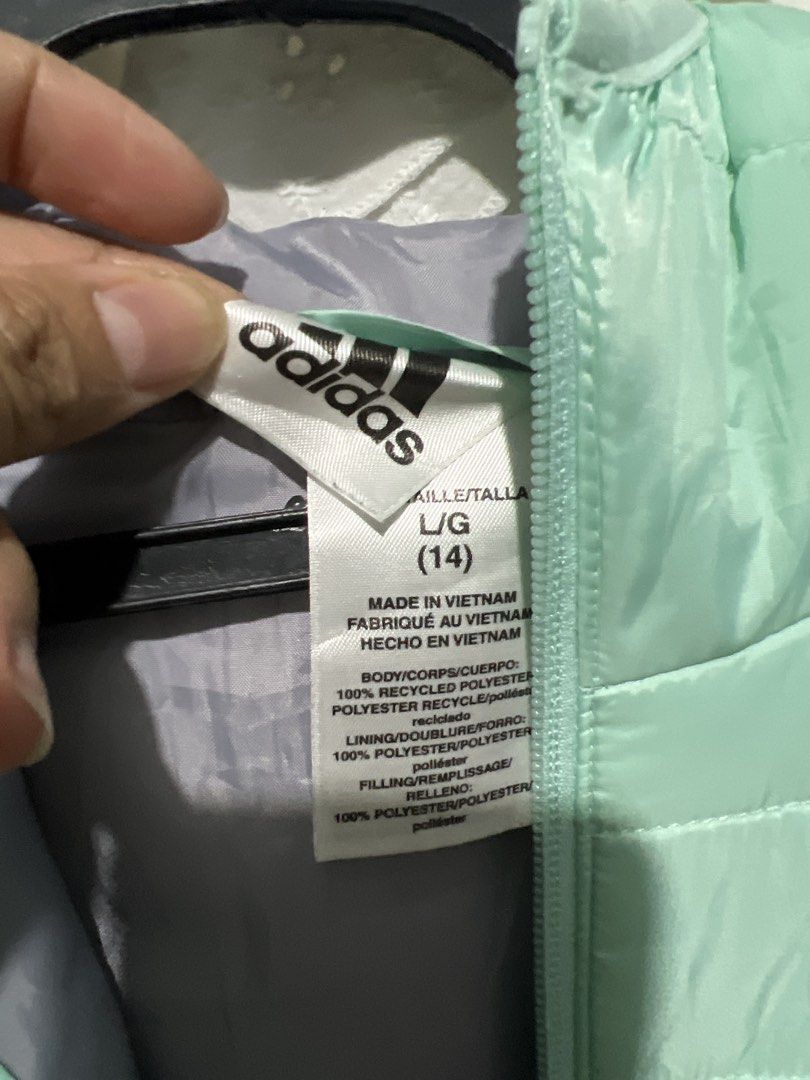 Adidas Puffer Jacket Mint Green (Category: Coats, Jackets and Outerwear) located in Rizal. Submitted by 411tatedgirl (Listing ID 1459795204, Image 3). Description: - Lightweight Adidas puffer jacket - Color: Mint green with grey sleeve stripes - Features a hood and full zip closure - Made in Vietnam - Material: 100% recycled polyester - Ideal for layering or cooler weather - XXS to Medium Adult Womens.