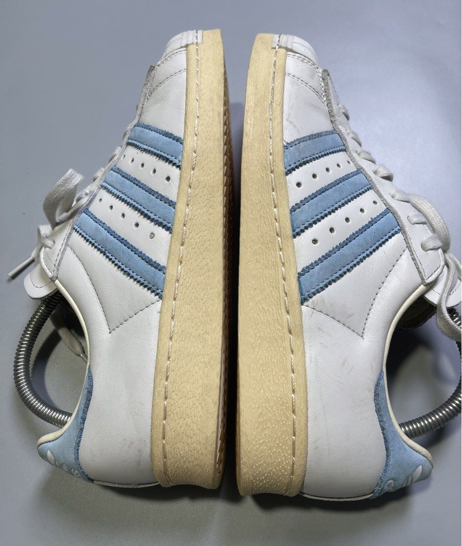 Adidas Superstar White Light Blue Stripes Shell Toe Sneakers (Category: Sneakers) located in Zamboanga. Submitted by laffthrift_23 (Listing ID 1459873785, Image 3). Description: - Classic Adidas Superstar sneakers - White leather with light blue stripes - Iconic shell toe design - Soles show some yellowing from age - Perfect for casual wear and vintage style.