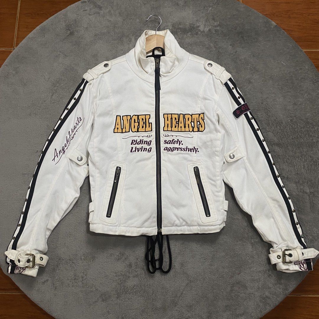 Angel Hearts x Simpson White Motorcycle Jacket (Category: Coats, Jackets and Outerwear) located in Naga. Submitted by ejdurante17 (Listing ID 1459744180, Image 1). Description: - White Angel Hearts x Simpson jacket - "Angel Hearts" text and "Riding Living, safety, aggressively." graphic on front - Lace-up detail at the back for adjustable fit - Buckle straps on cuffs and sides for added style and customization - Versatile for both riding and casu