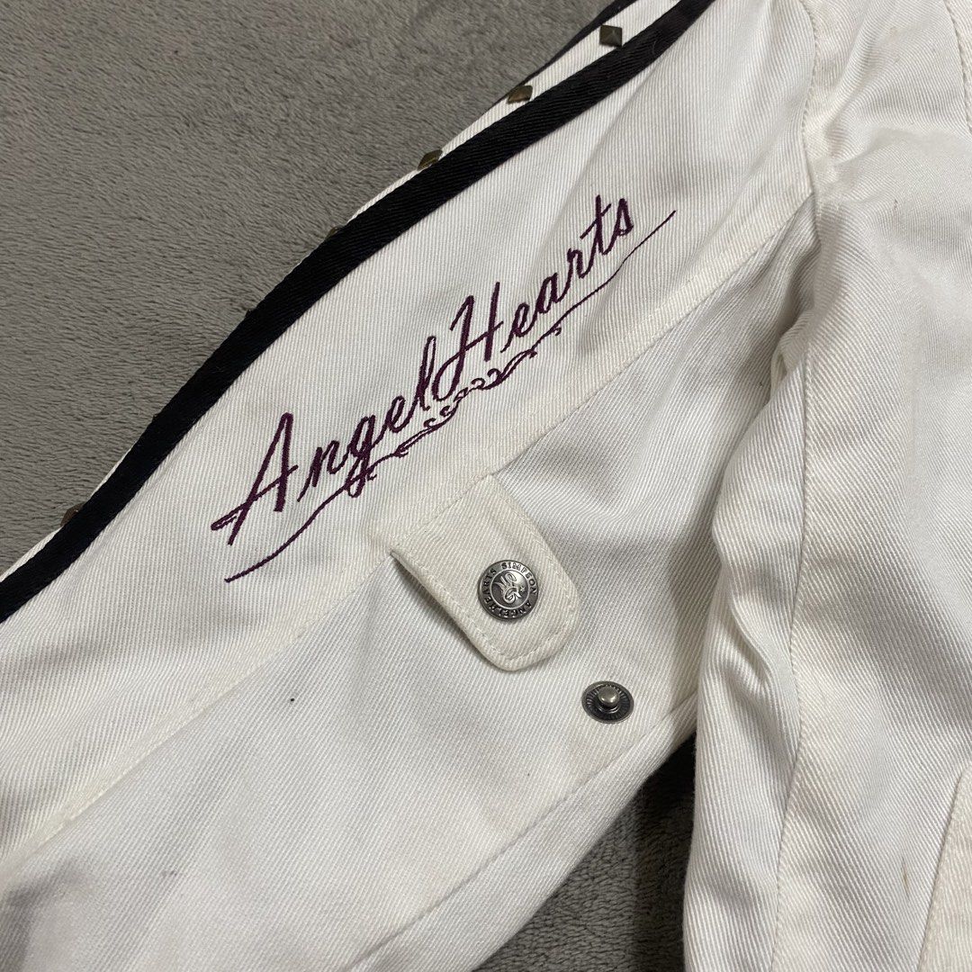 Angel Hearts x Simpson White Motorcycle Jacket (Category: Coats, Jackets and Outerwear) located in Naga. Submitted by ejdurante17 (Listing ID 1459744180, Image 2). Description: - White Angel Hearts x Simpson jacket - "Angel Hearts" text and "Riding Living, safety, aggressively." graphic on front - Lace-up detail at the back for adjustable fit - Buckle straps on cuffs and sides for added style and customization - Versatile for both riding and casu