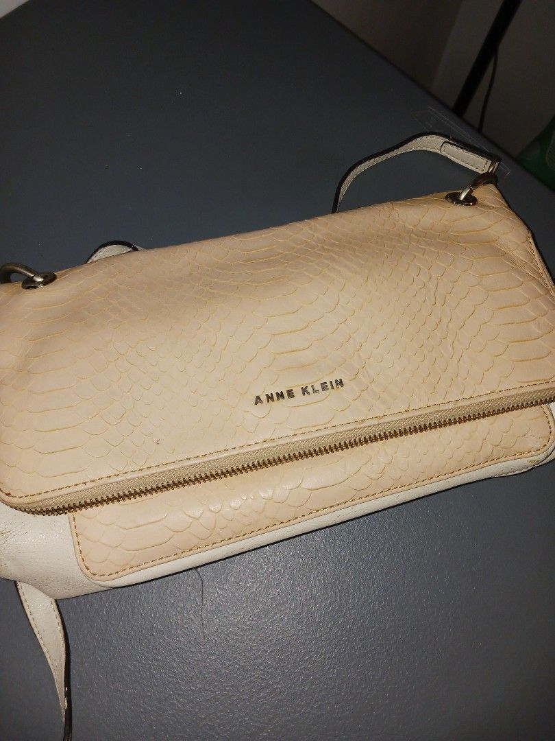 Anne Klein Cream Textured Shoulder Bag (Category: Shoulder Bags) located in Quezon City. Submitted by rdonelle (Listing ID 1459775925, Image 1). Description: - Cream colored shoulder bag by Anne Klein - Textured exterior with elegant gold chain details - Secure zipper closure - Adjustable strap for comfortable wear - Versatile for everyday use or evening events - Spacious interior.