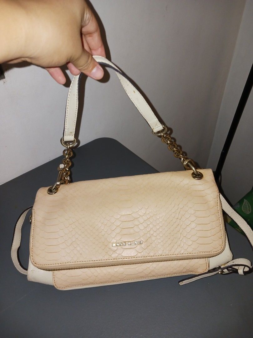 Anne Klein Cream Textured Shoulder Bag (Category: Shoulder Bags) located in Quezon City. Submitted by rdonelle (Listing ID 1459775925, Image 2). Description: - Cream colored shoulder bag by Anne Klein - Textured exterior with elegant gold chain details - Secure zipper closure - Adjustable strap for comfortable wear - Versatile for everyday use or evening events - Spacious interior.
