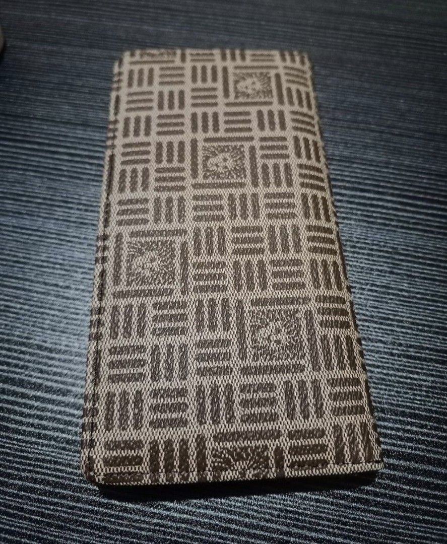 Anne Klein Medium Bifold Brown Monogram Wallet (Category: Wallets & Card holders) located in Manila. Submitted by iamsaeemieese (Listing ID 1459856552, Image 2). Description: - Chic brown wallet with repeating geometric monogram pattern. - Features a subtle gold-toned emblem on the front. - Slim profile, designed for easy pocket storage. - Ideal for organizing cards and cash. - Interior is clean and well-maintained..