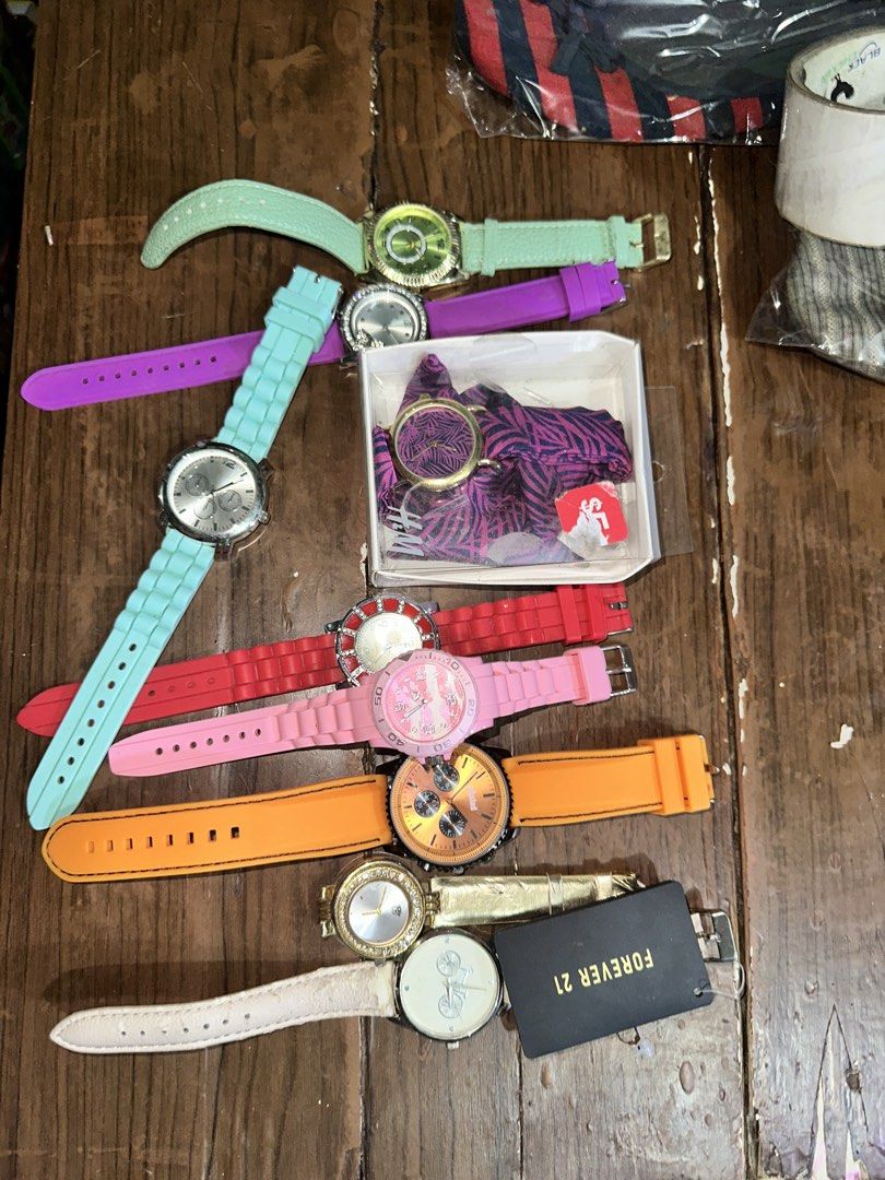 Assorted Silicone Strap Watches Bundle (Category: Women's Watches) located in Manila. Submitted by edgiedge (Listing ID 1459868626, Image 3). Description: - Bundle of 9 watches - Includes 6 colorful silicone strap watches: mint green, purple, light blue, red, pink, and orange - 1 gold-tone watch with a white strap and a black Forever 21 tag - Some watches feature decorative faces - Ideal for everyday wear or as fun, vibrant accessories No batteri