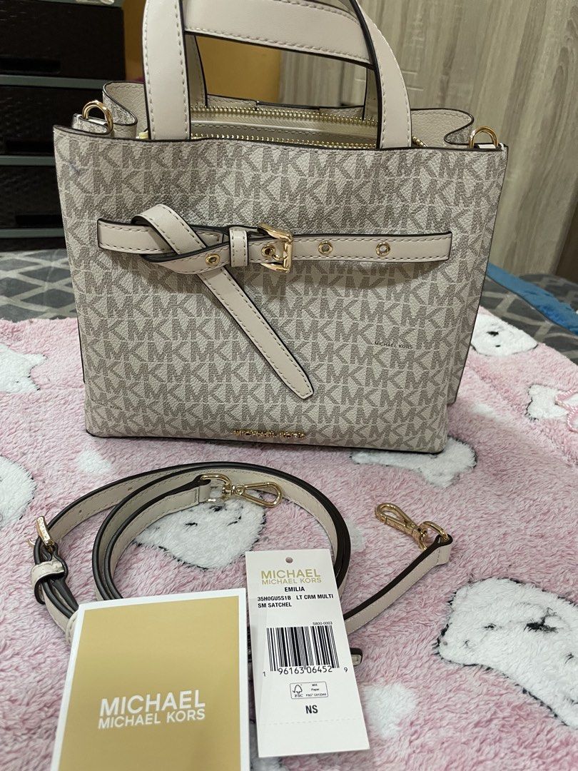 Authentic MK Emilia med satchel (Category: Cross-body Bags) located in Bulacan. Submitted by queendiday13 (Listing ID 1459765385, Image 1). Description: Authentic,US bought thru personal shopper Med size with sling 2 open compartments,1 zipped Signature logo in vanilla color.