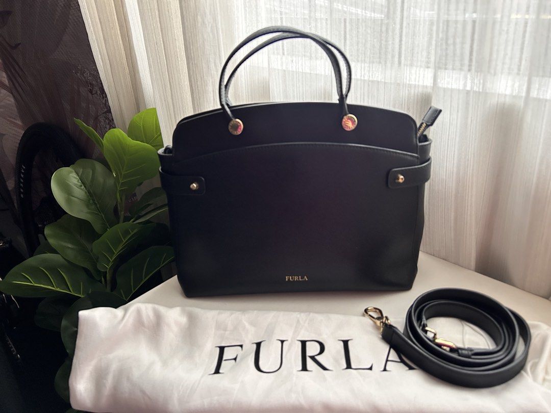 Authentic Piper Black Leather Tote Bag with Shoulder Strap (Category: Luxury Bags & Wallets) located in Santa Rosa. Submitted by jolels (Listing ID 1459693385, Image 1). Description: - Authentic Classic black leather tote by Furla - Bought from Tokyo (Php 20k) -Features top handles and a detachable shoulder strap - Elegant gold hardware details - Spacious interior for all your essentials - Comes with original Furla dust bag - Ideal for everyday u