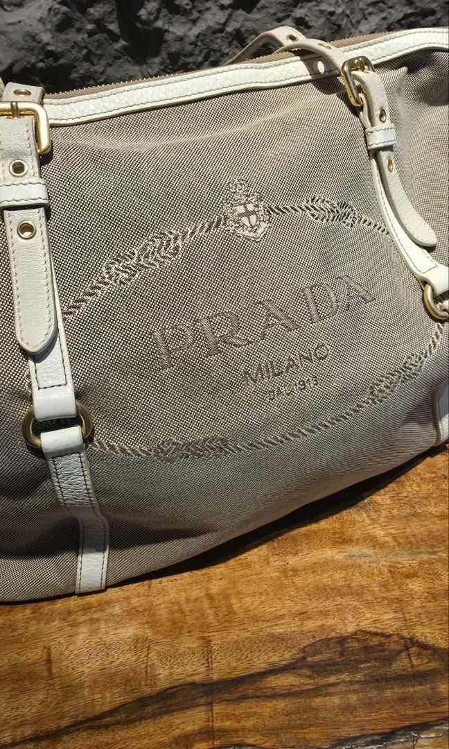 Authentic Prada Beige jacquard logo tote (Category: Luxury Bags & Wallets) located in Quezon City. Submitted by jhaediah (Listing ID 1379263475, Image 3). Description: original preloved with stain Bag only.