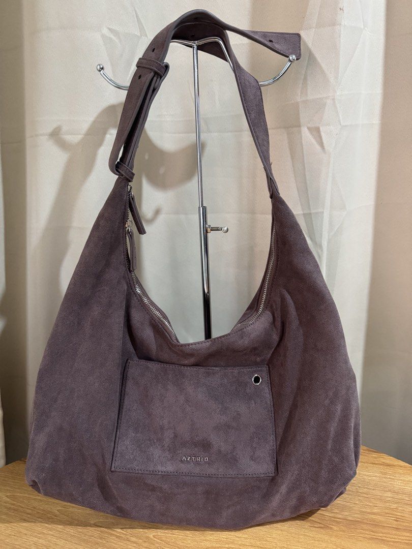 AZTRID Suede Hobo Bag (Category: Shoulder Bags) located in Quezon City. Submitted by areux (Listing ID 1459773723, Image 1). Description: A roomy and stylish everyday bag with a soft suede-like finish and adjustable strap. The neutral gray-brown/taupe shade is easy to pair with almost any outfit, whether casual or dressed up. ✨ Features: • Large hobo/sling bag design • Can be worn as a shoulder or crossbody bag • Adjustable strap with multiple ho