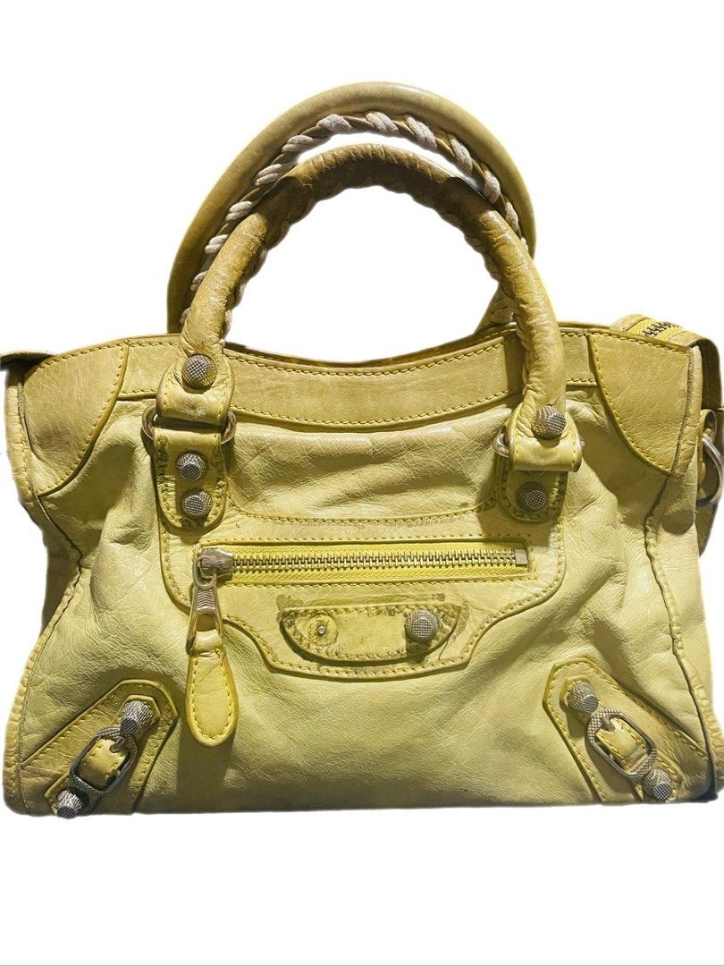 Balenciaga City Bag (Category: Luxury Bags & Wallets) located in Caloocan City. Submitted by hardestea2026 (Listing ID 1459697994, Image 1). Description: - Authentic Yellow Balenciaga City Bag - Features classic front zip pocket - Braided, leather-wrapped handles - Signs of wear on leather and hardware, adding character - Perfect for everyday use - Comes with original dust bag.