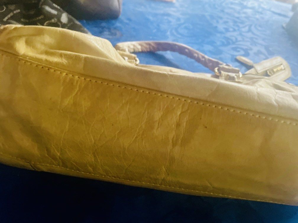 Balenciaga City Bag (Category: Luxury Bags & Wallets) located in Caloocan City. Submitted by hardestea2026 (Listing ID 1459697994, Image 3). Description: - Authentic Yellow Balenciaga City Bag - Features classic front zip pocket - Braided, leather-wrapped handles - Signs of wear on leather and hardware, adding character - Perfect for everyday use - Comes with original dust bag.