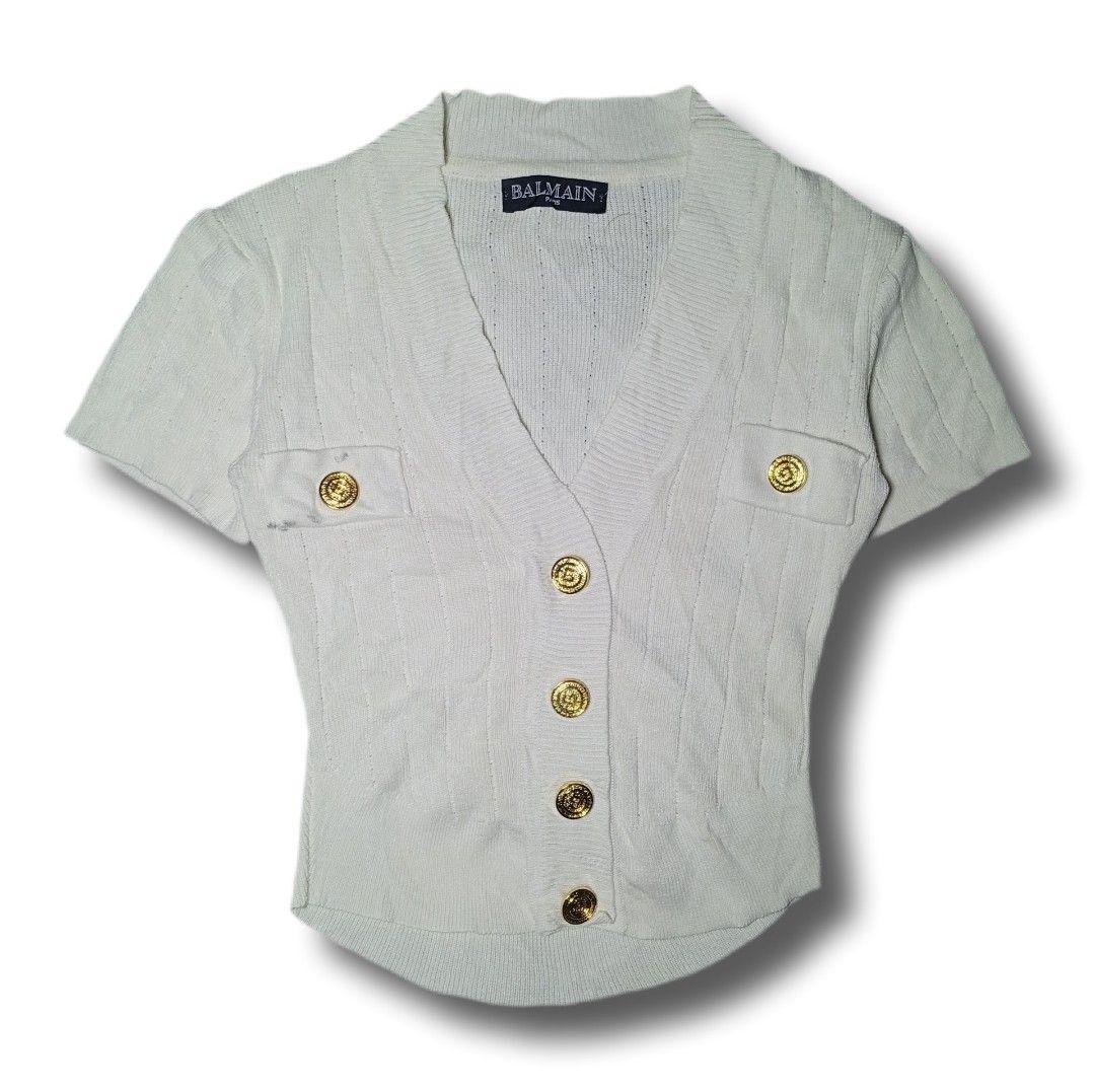 Balmain Paris Short Sleeve Button Up Cardigan (Category: Coats, Jackets and Outerwear) located in Davao. Submitted by tj-289a (Listing ID 1459798242, Image 1). Description: - Balmain Paris short sleeve cardigan - Features elegant gold button details - Two functional chest pockets - Chic ribbed knit texture - Classic V-neckline - Versatile for layering or standalone wear.