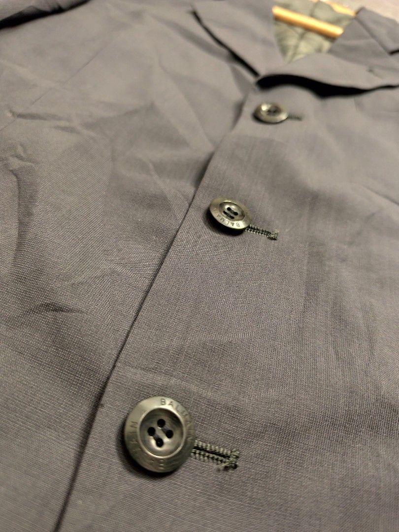 Balmain Paris Suit Blazer (Category: Luxury Apparel) located in Cordova. Submitted by bsb.streetluxvintage.clothing (Listing ID 1459791862, Image 3). Description: - Authentic Balmain Paris blazer - Elegant dark grey color - Classic three-button closure - Two functional front pockets - Signature Balmain Paris engraved buttons - Interior lined with iconic Balmain Paris pattern - Perfect for both formal events and casual styling.