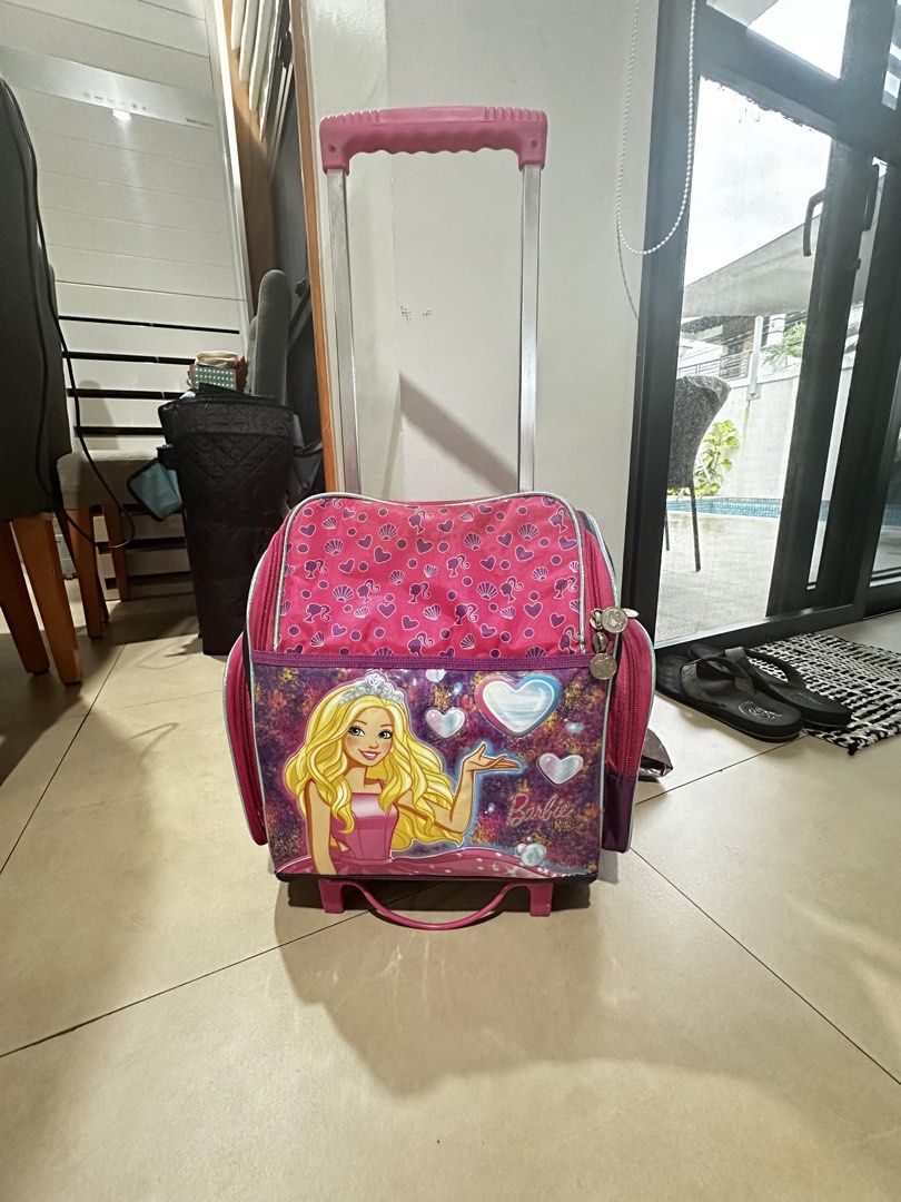 Barbie school trolly wheels bag (Category: Backpacks) located in Angeles City. Submitted by luxenstuff (Listing ID 1459791464, Image 2). Description: Barbie design pink purple Height 12in Width 6.5in Length 11in Lunch bag - 9in x 6.5in x 5.5in .
