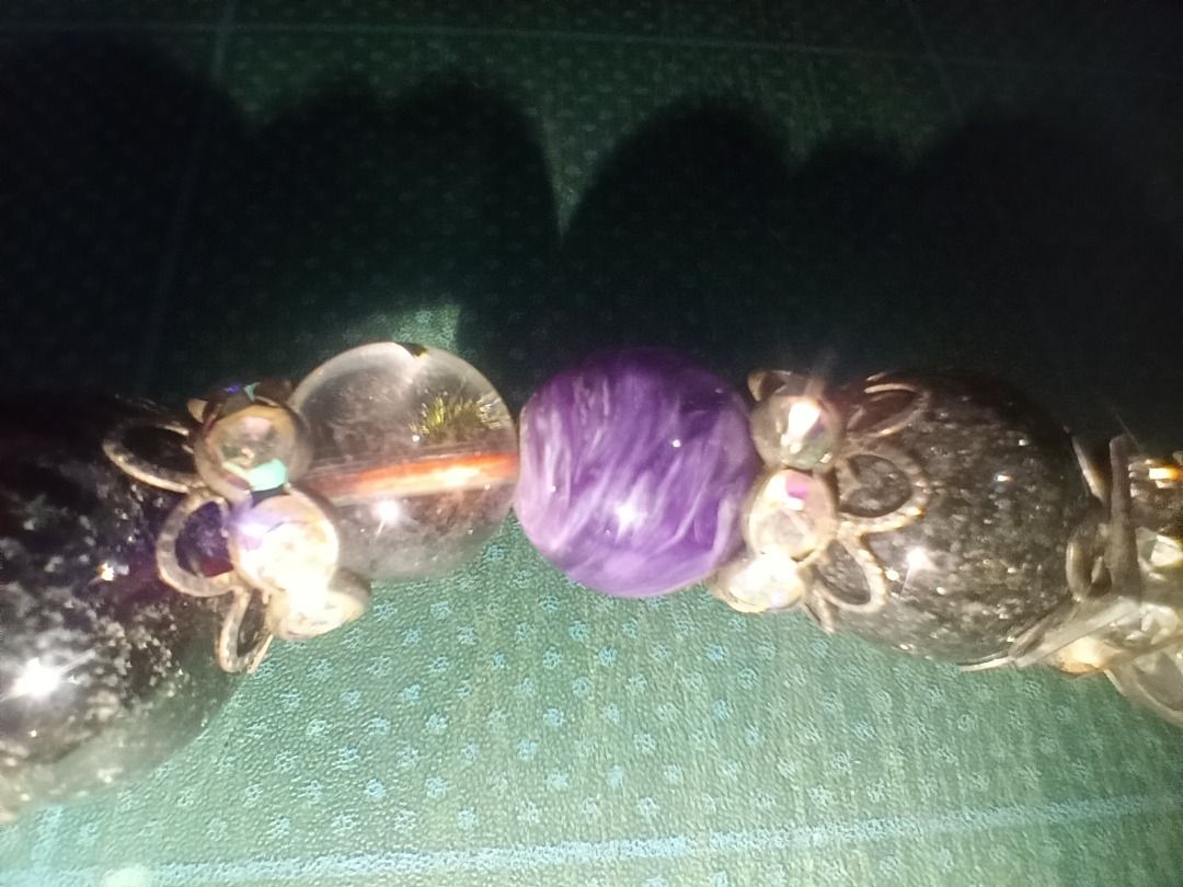 Beaded Bracelet with Charms and Gemstones (Category: Bracelets) located in Munoz. Submitted by larryc1212 (Listing ID 1459812932, Image 3). Description: - Unique beaded bracelet - Mix of large and small beads - Various colors and textures: clear with inclusions, purple stones, red stones, black speckled beads - Ornate silver-tone charms - Stretchy design for easy wear - Perfect statement piece for any outfit Disclaimer: Item may include some scra