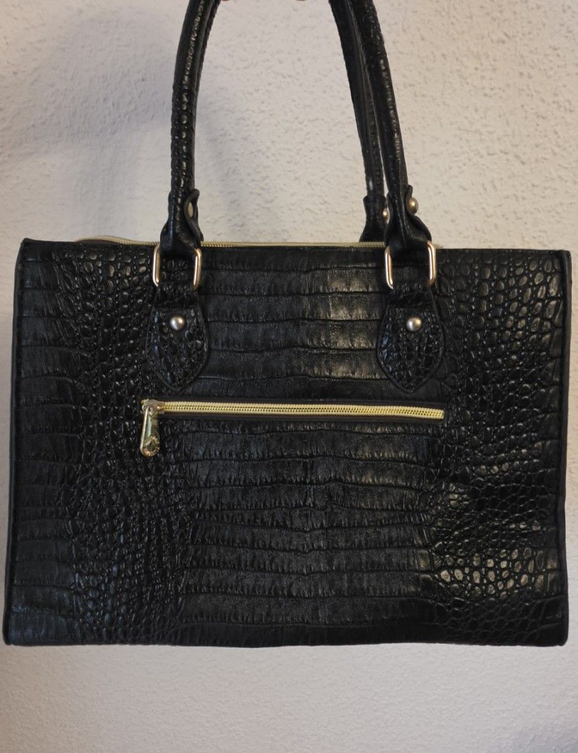Black Crocodile Embossed Handbag with Bow Detail (Category: Luxury Bags & Wallets) located in Manila. Submitted by amc88 (Listing ID 1459698020, Image 2). Description: - Stylish black handbag with a luxurious crocodile embossed texture. - Adorable bow detail on the front for a feminine touch. - Elegant gold hardware accents throughout. - Convenient zippered pocket on the back for quick access. - Comfortable top handles for easy carrying. - Spacio