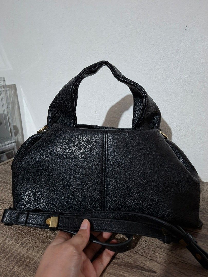 Black Faux Leather Handbag (Category: Shoulder Bags) located in Angeles City. Submitted by closetbydey (Listing ID 1459796439, Image 2). Description: - Textured faux leather handbag - Magnetic snap closure - Detachable shoulder strap.