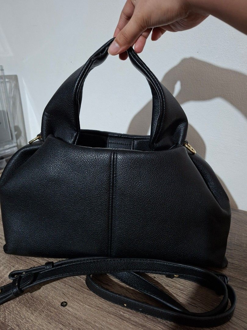 Black Faux Leather Handbag (Category: Shoulder Bags) located in Angeles City. Submitted by closetbydey (Listing ID 1459796439, Image 3). Description: - Textured faux leather handbag - Magnetic snap closure - Detachable shoulder strap.