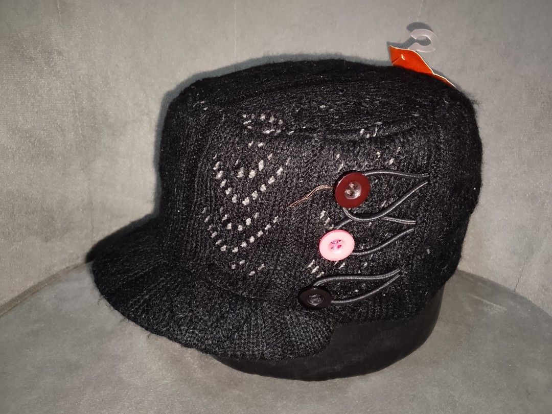 Black Knit Cadet/Military Style Cap (Category: Hats & Beanies) located in Binangonan. Submitted by yuristalin888 (Listing ID 1459826417, Image 2). Description: This cozy black knit cadet/military-style cap features a textured knit pattern with subtle grey speckling, a flat-top crown, and a curved brim. It is uniquely accented on the side with three decorative buttons in contrasting colors secured by looped cords..