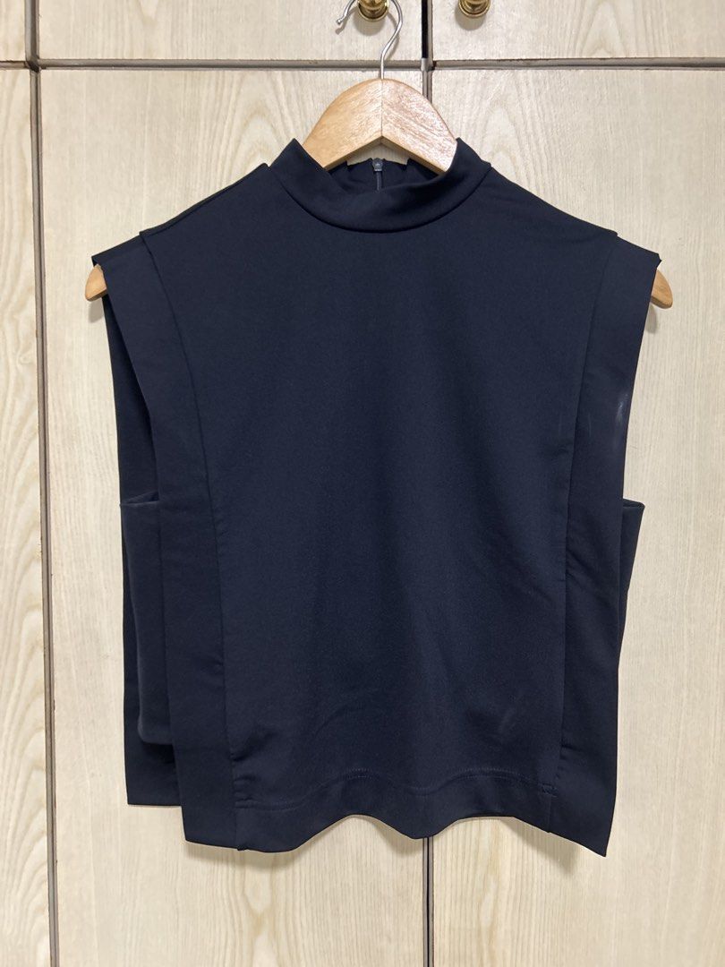Navy Blue Mock Neck Sleeveless Cropped Top (Category: Sleeveless) located in Makati City. Submitted by leannd (Listing ID 1459784630, Image 1). Description: - Sleek sleeveless top - Elegant mock neck design - Flattering cropped length - Structured shoulder detail for a modern look - Convenient back zipper closure - Versatile piece: great for layering or wearing alone.