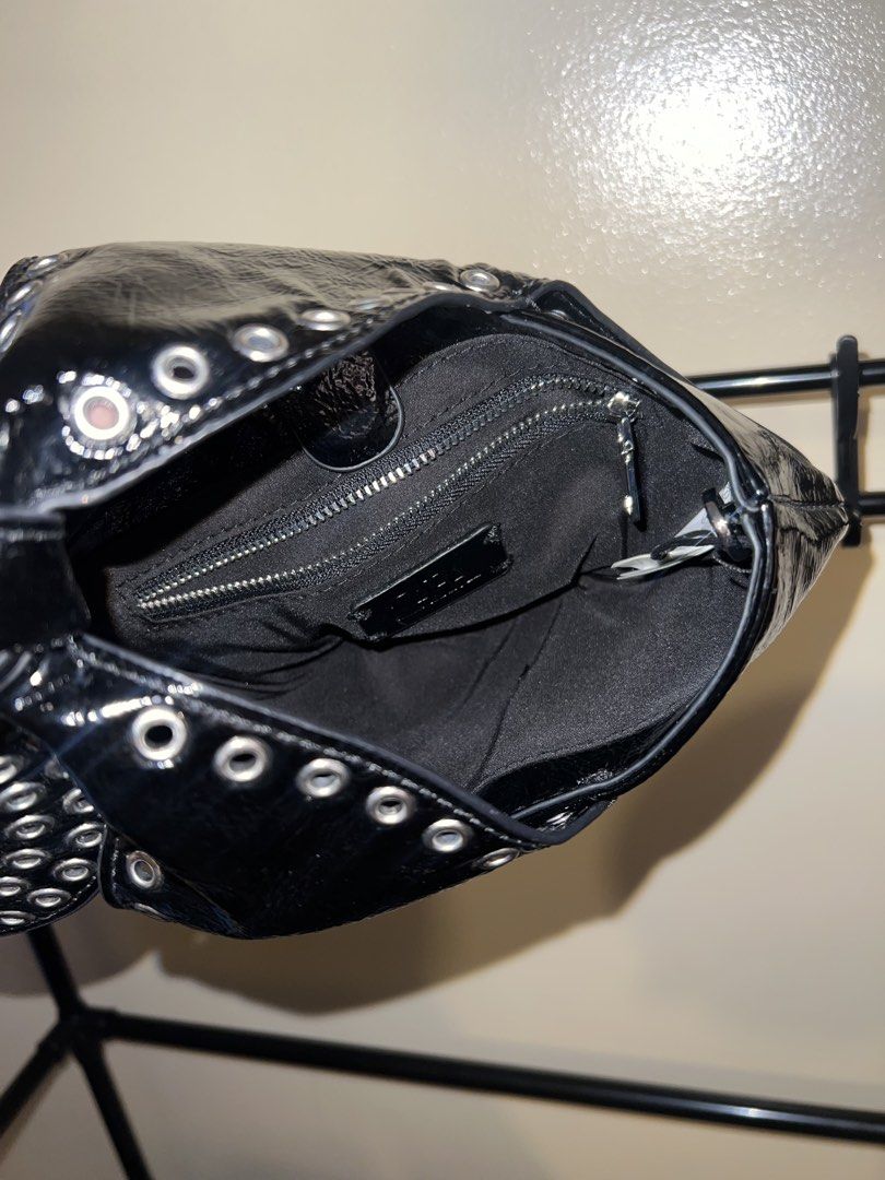 Black Patent Studded Knot/Dumpling Handbag (Category: Tote Bags) located in Mandaluyong City. Submitted by chelseayb47224 (Listing ID 1459821109, Image 3). Description: - Used once - Unique knotted dumpling design - Silver studs all around - Zipper closure inside - Small size, perfect for essentials - Adds an edgy vibe to any outfit - Check photos for details.